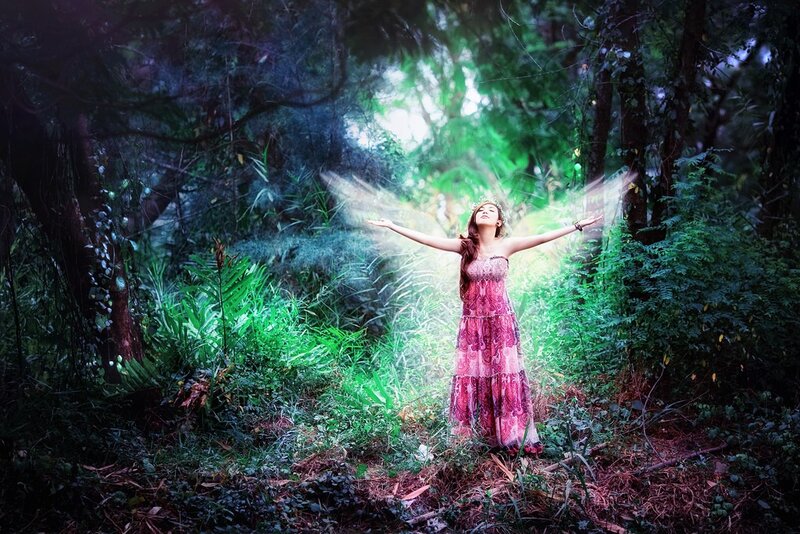 woman with angel wings in forest