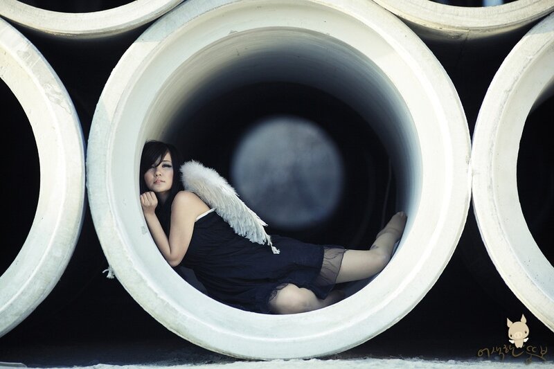 woman with angel wings in pipe