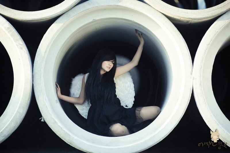 woman with angel wings in pipe