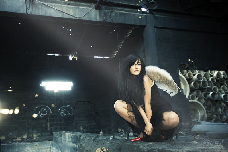 woman with angel wings in warehouse