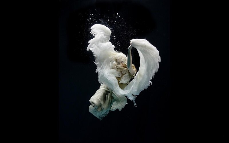 woman with angel wings underwater