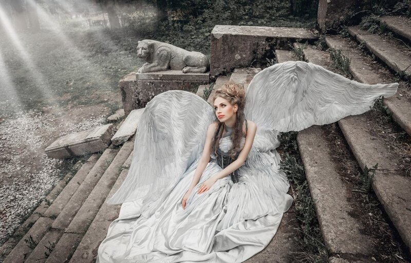 Woman with Angel Wings — White, Dramatic, Photograph, Stone Steps