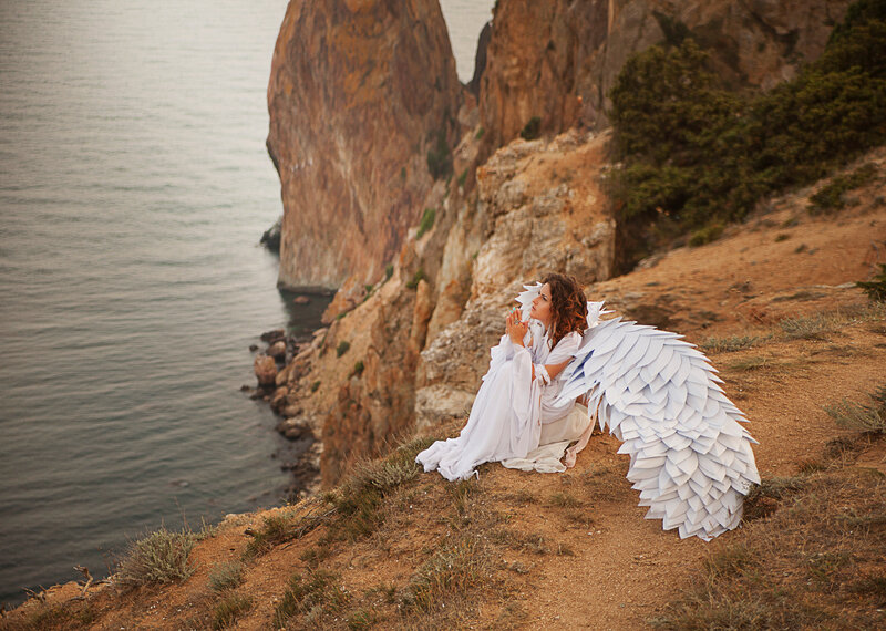 Woman with Angel Wings — White, Serene, Sunset, Photograph, Cliffs