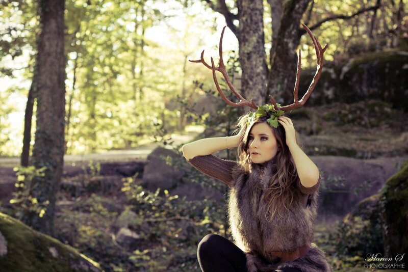 woman with antlers in forest