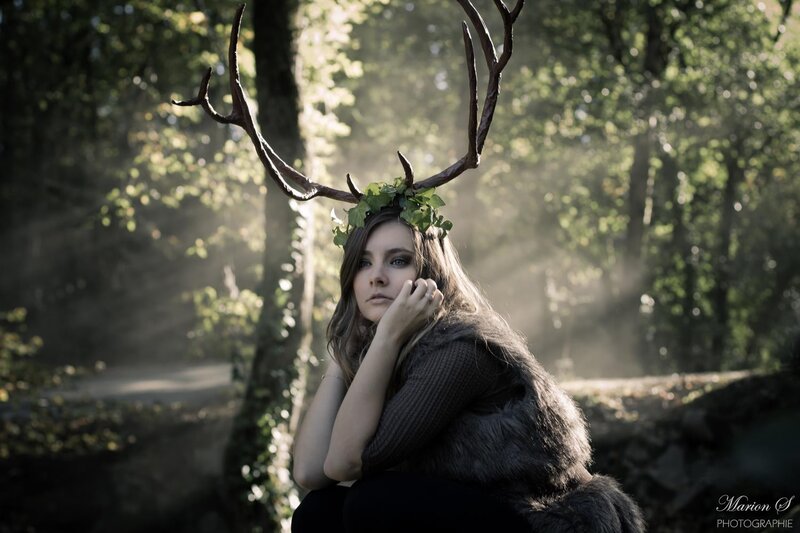 woman with antlers in forest