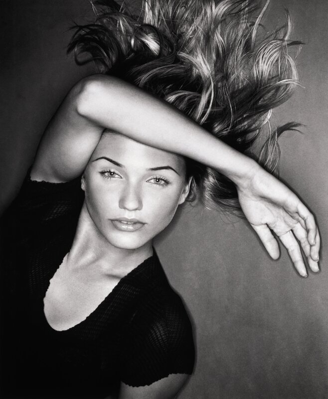 woman with arm over face