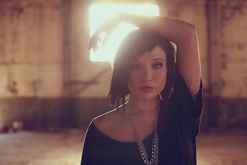woman with arm raised in light