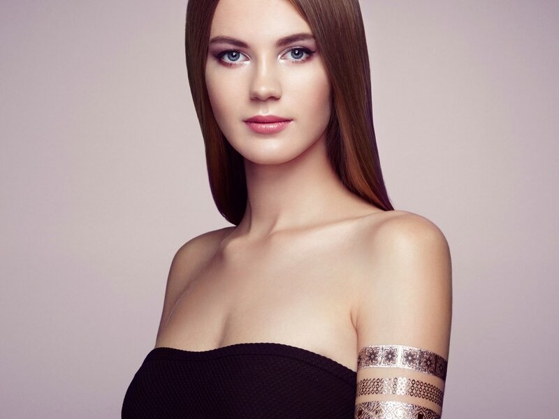 Woman with Arm Tattoos — Brown