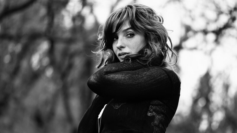 woman with arms crossed outdoors