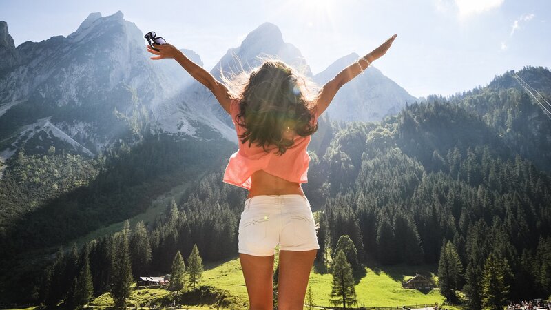 Woman with arms outstretched in mountains