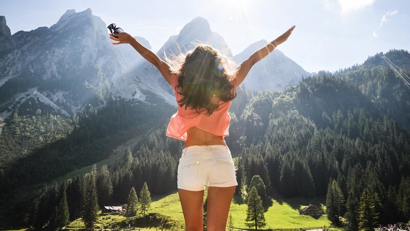 Woman with arms outstretched in mountains