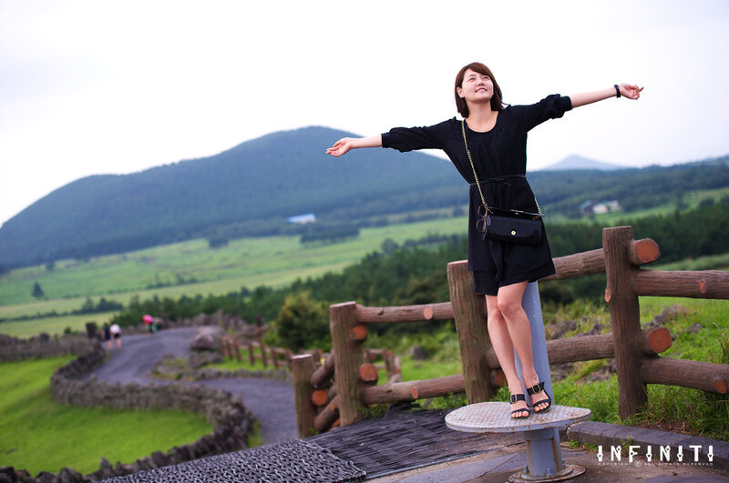 Woman with arms outstretched on a hill