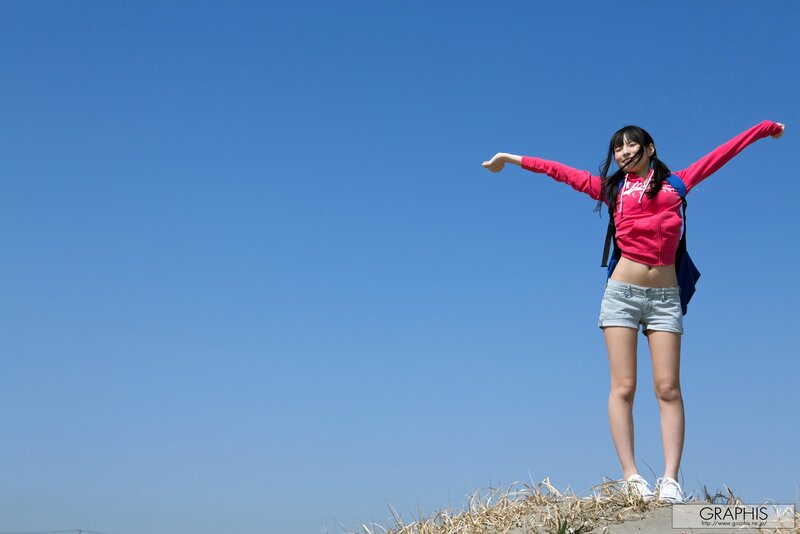 Woman with arms outstretched on a hill