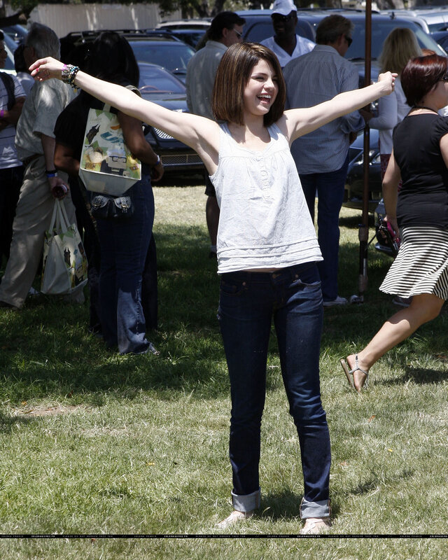woman with arms outstretched on grass