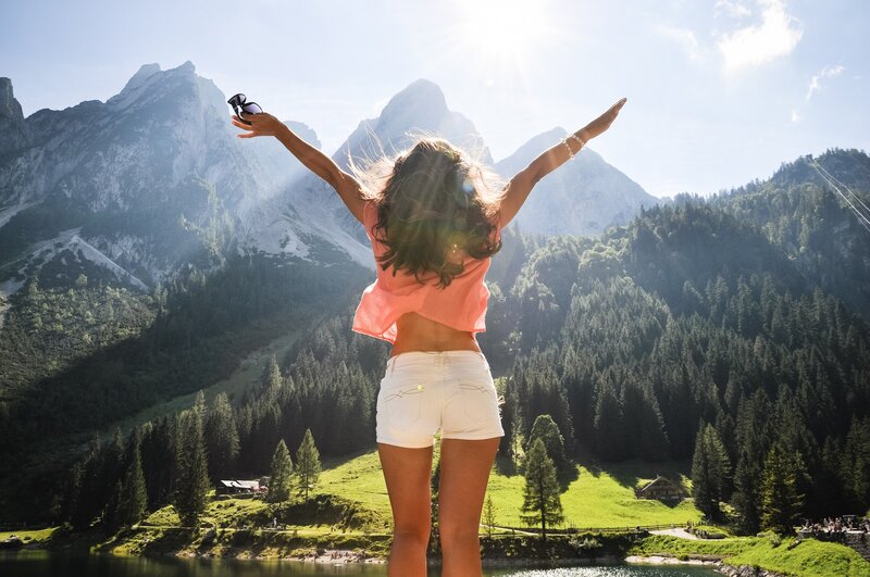 Woman with arms raised in mountains