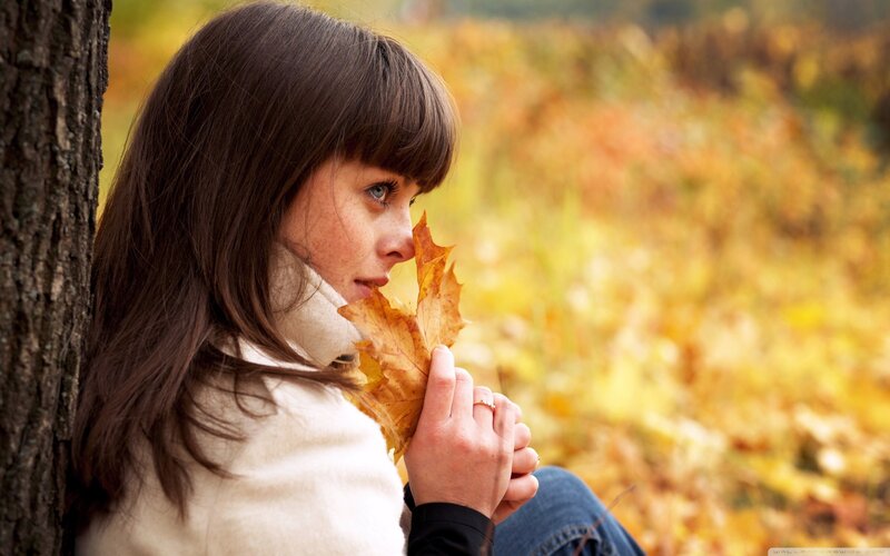 woman with autumn leaf
