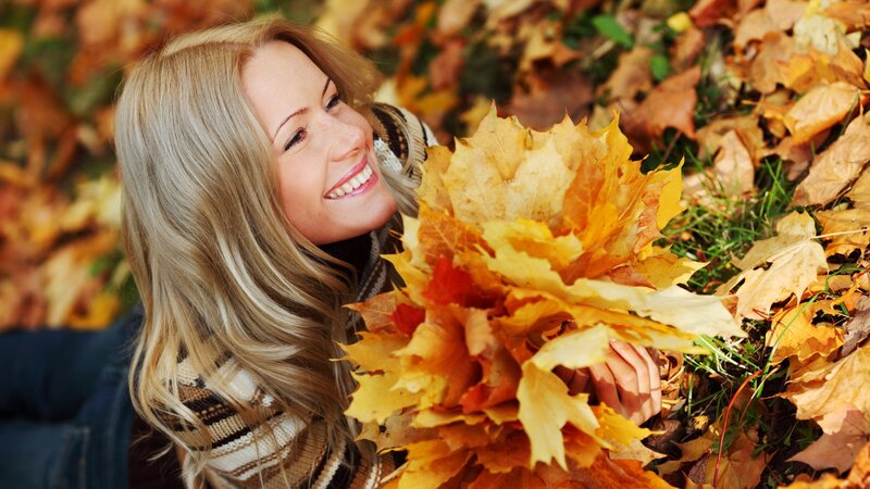 woman with autumn leaves