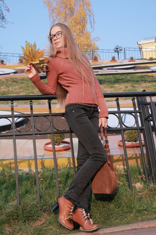 Woman with autumn leaves