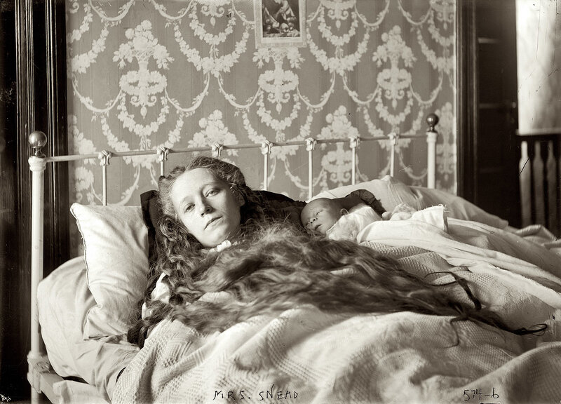 Woman with Baby in Bed