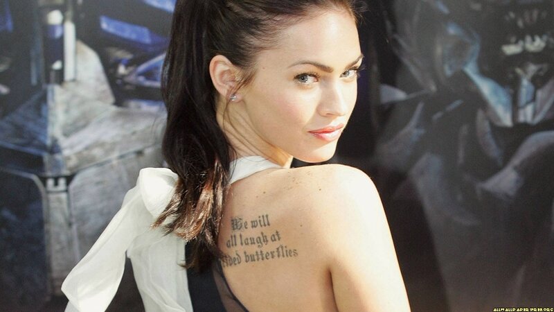 woman with back tattoo