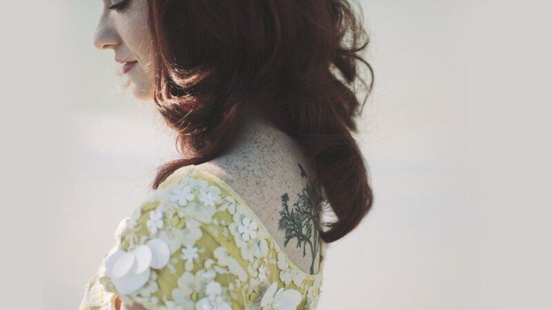 woman with back tattoo
