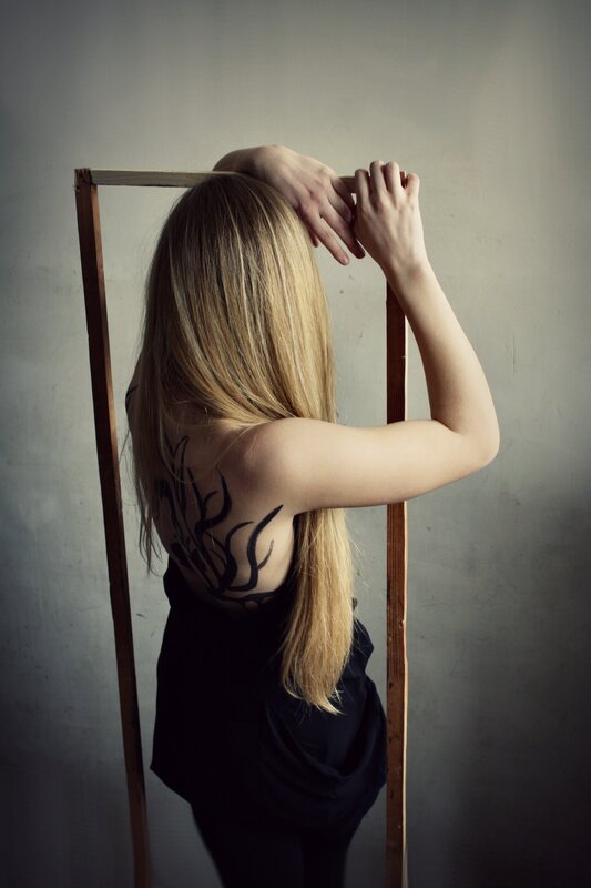 woman with back tattoo