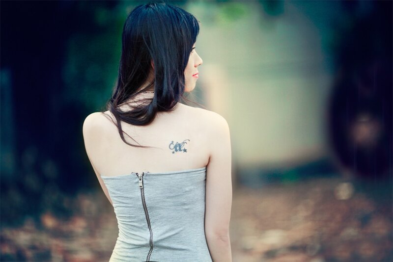 Woman with Back Tattoo — Gray, Contemplative