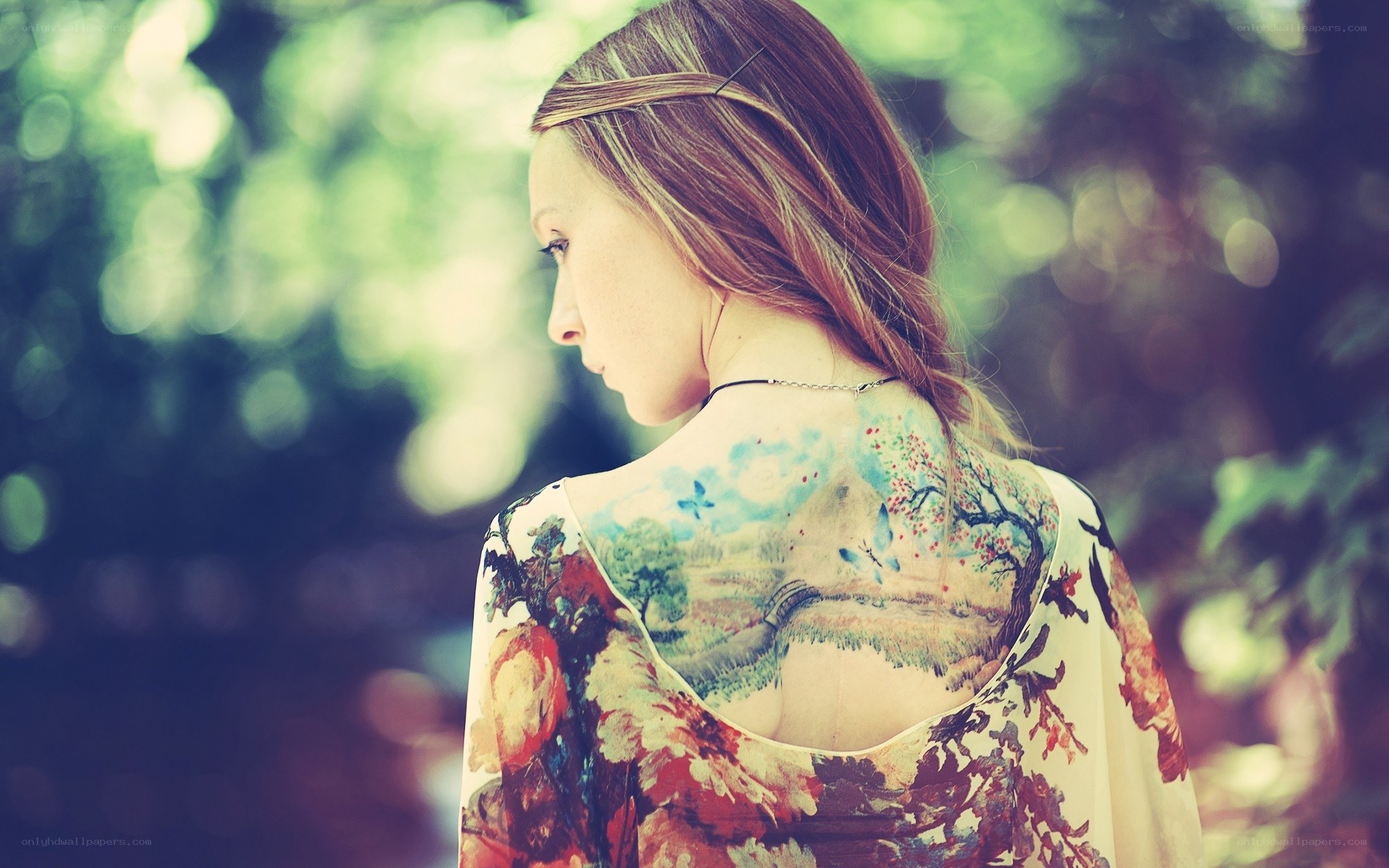 woman with back tattoo