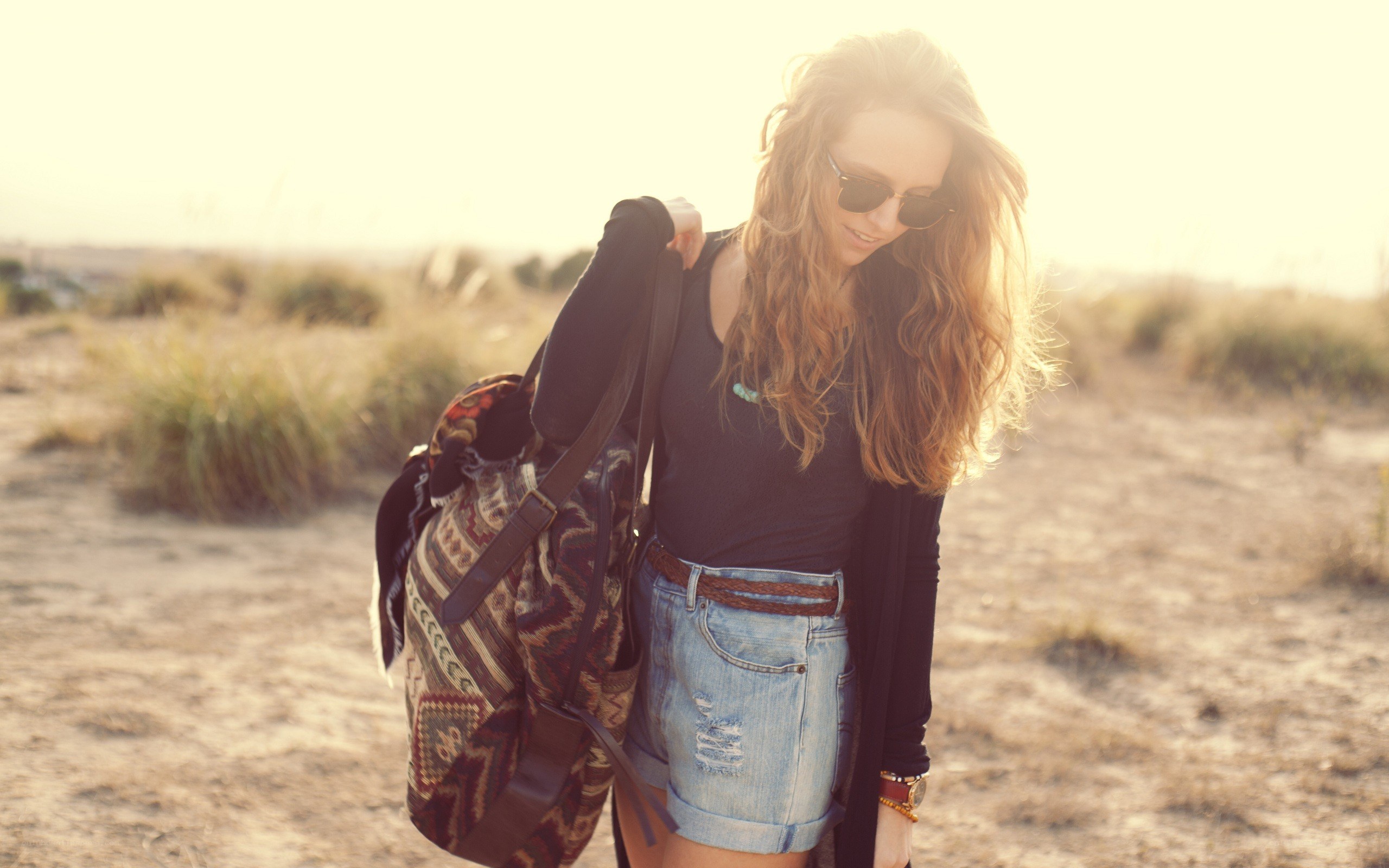 woman with backpack in field