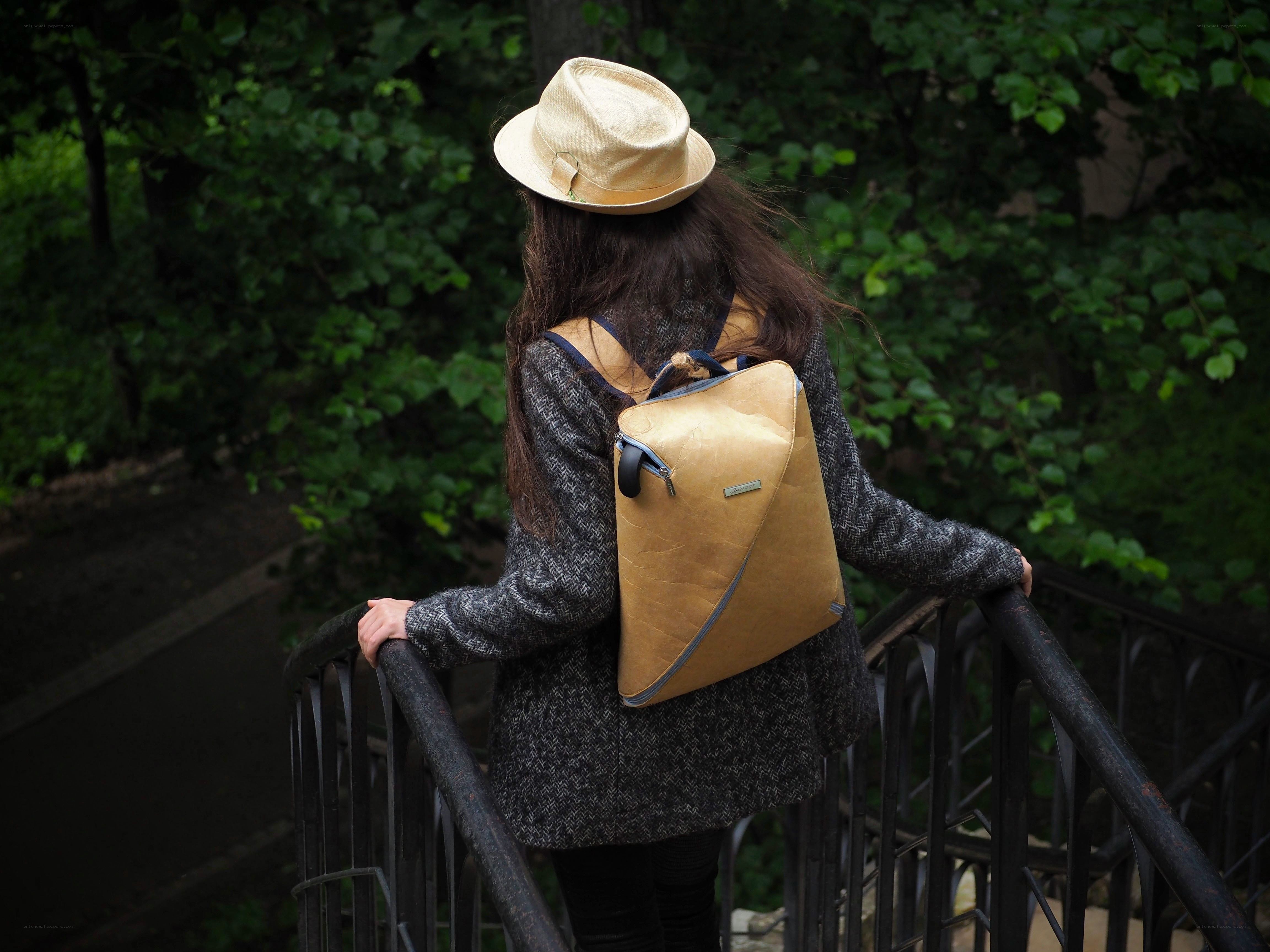 Woman with backpack on bridge
