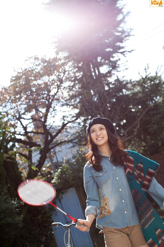 Woman with badminton racket outdoors