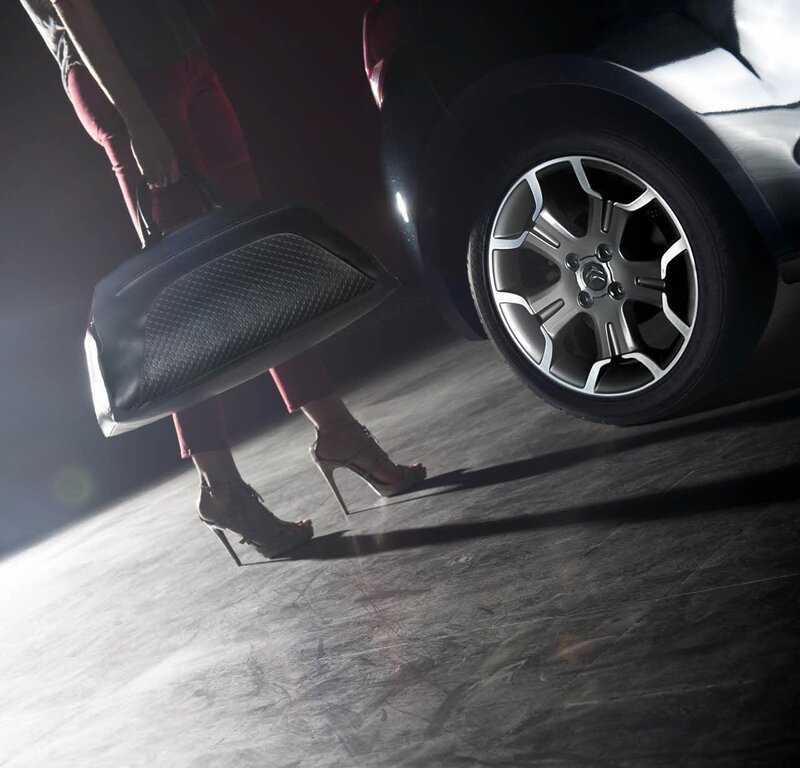 woman with bag near car