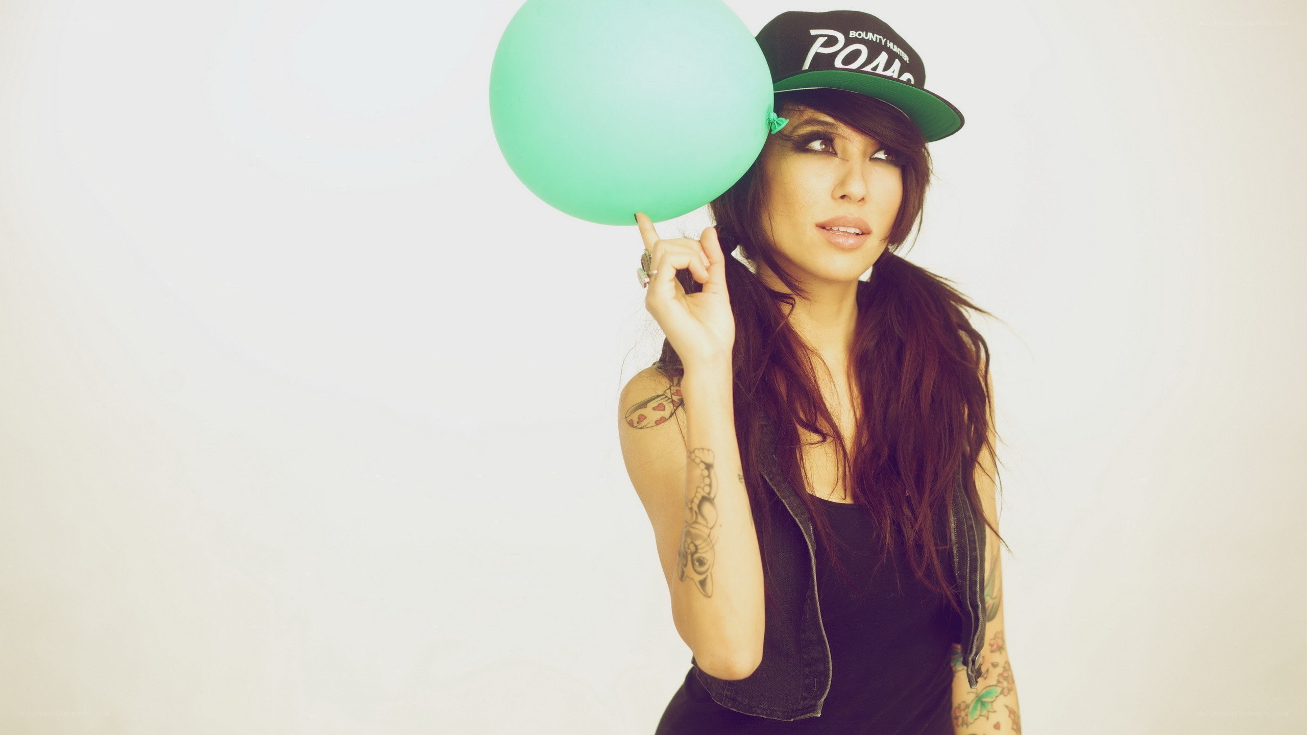 woman with balloon and cap