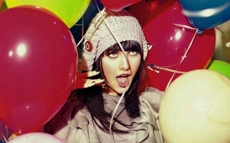 woman with balloons and beanie