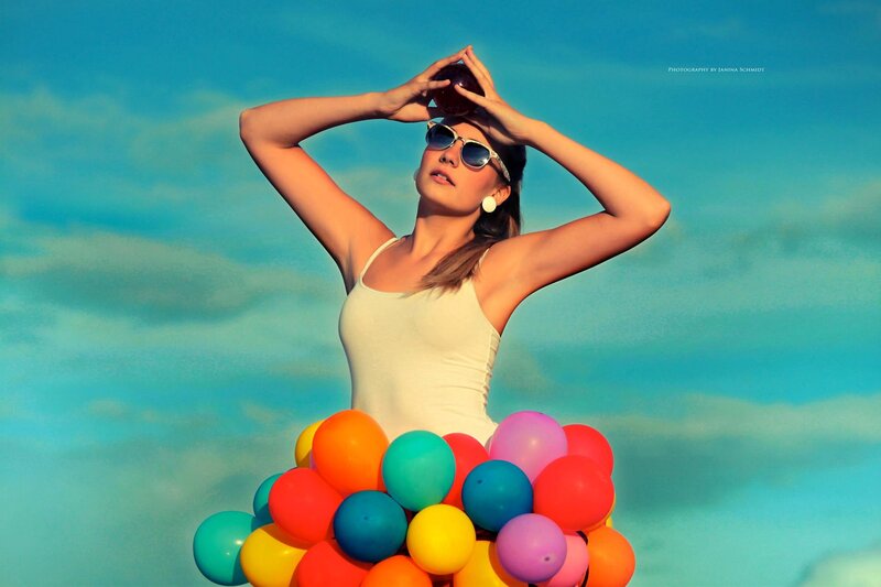 woman with balloons and sunglasses