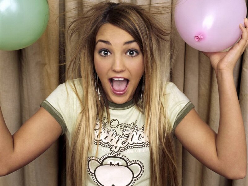 woman with balloons and surprised expression