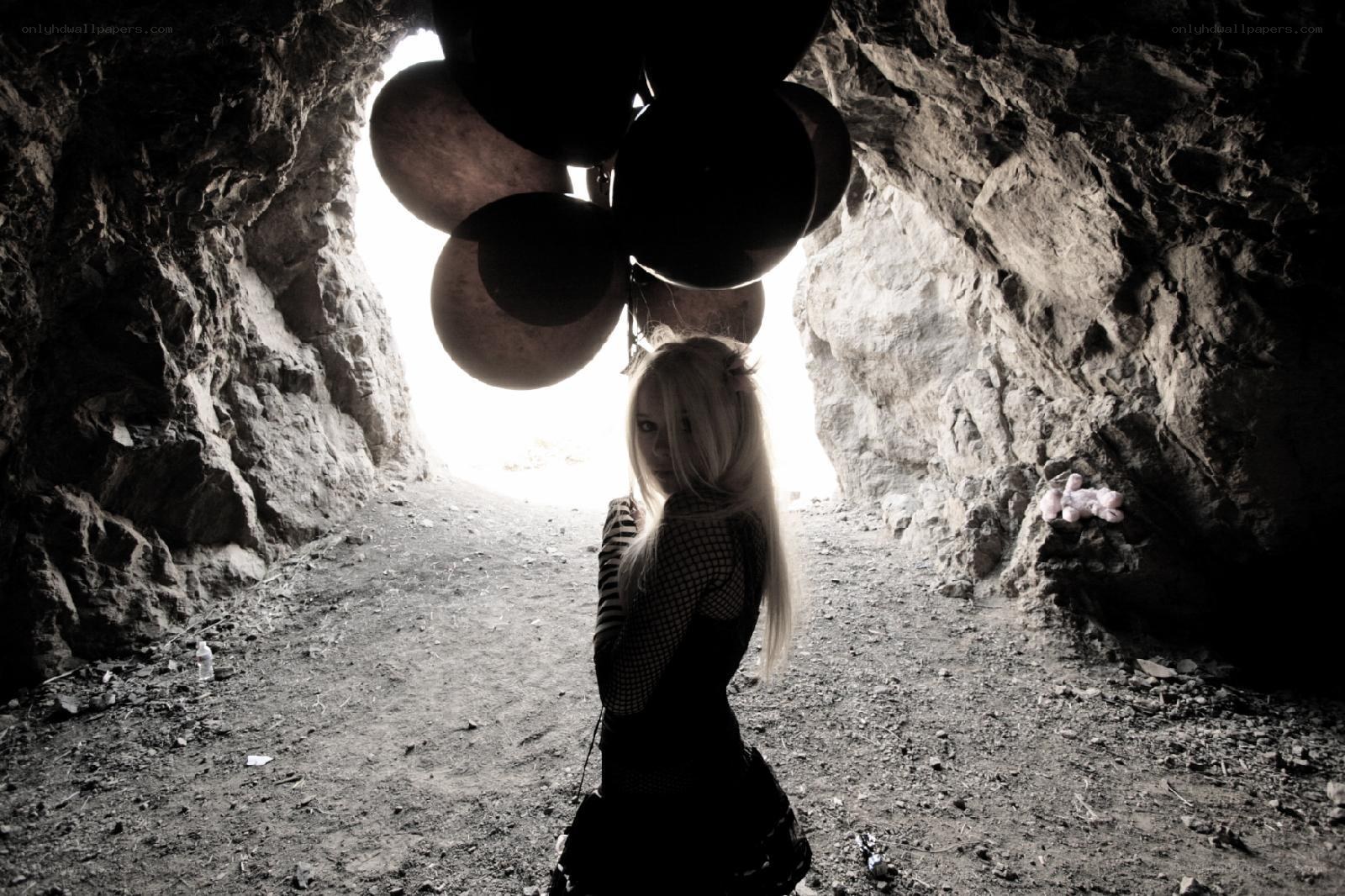 woman with balloons in cave