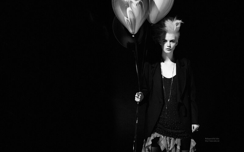 woman with balloons in dark