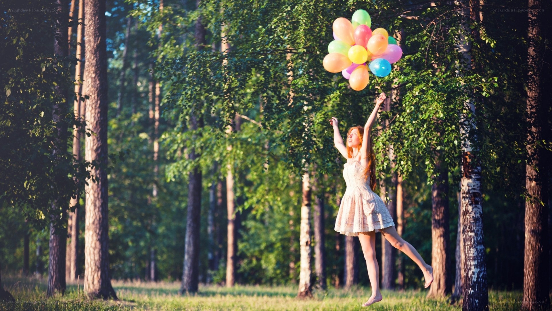 Woman with balloons in forest