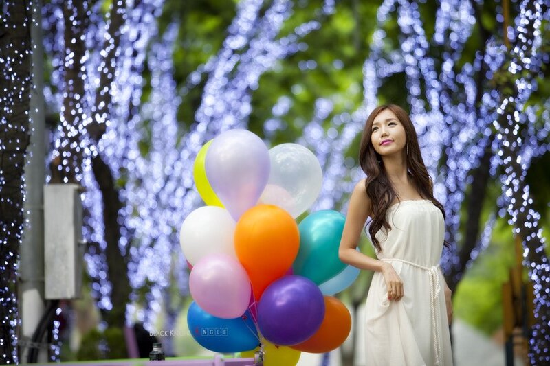 Woman with balloons in lights