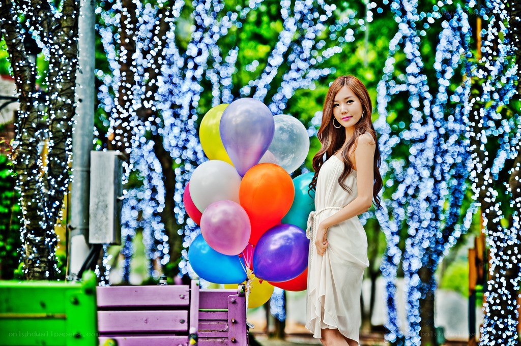 Woman with balloons in lights
