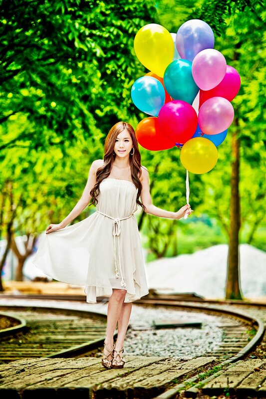 Woman with balloons in park