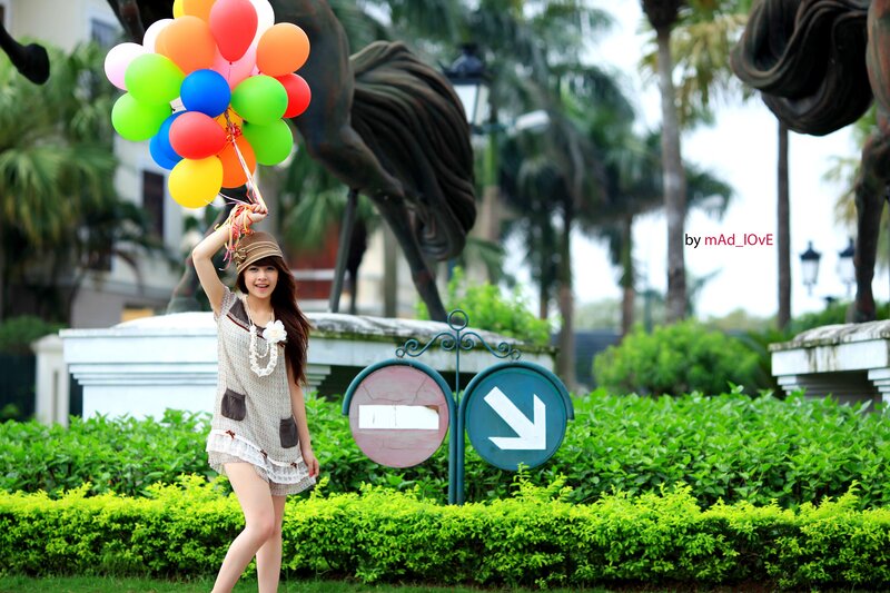 Woman with balloons in park