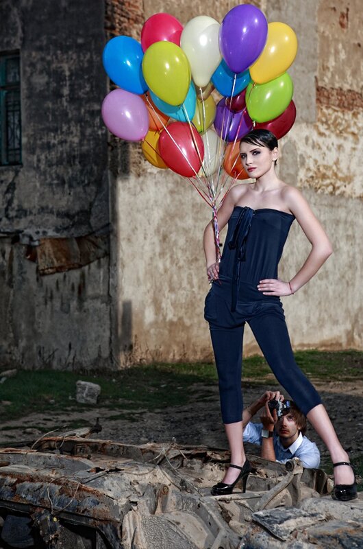 Woman with balloons in ruins