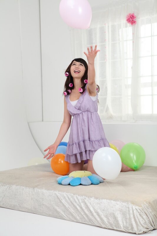 woman with balloons on bed