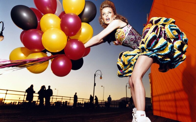 Woman with balloons on pier