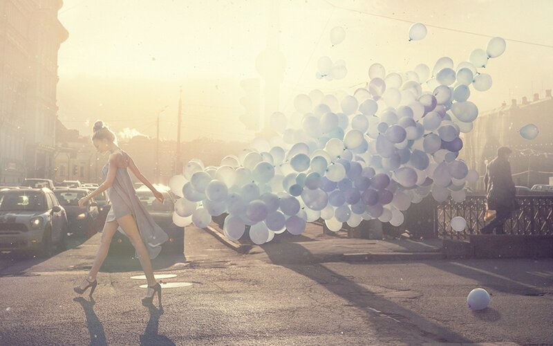 Woman with balloons on street