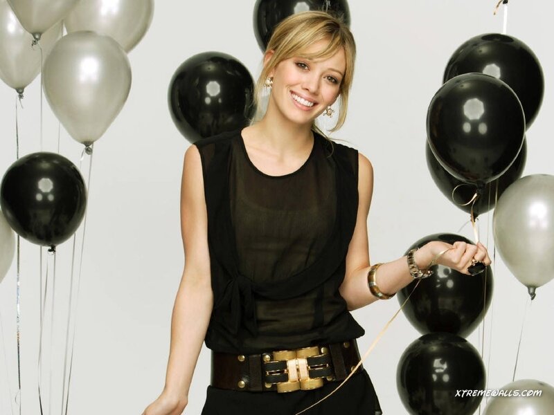 woman with balloons smiling