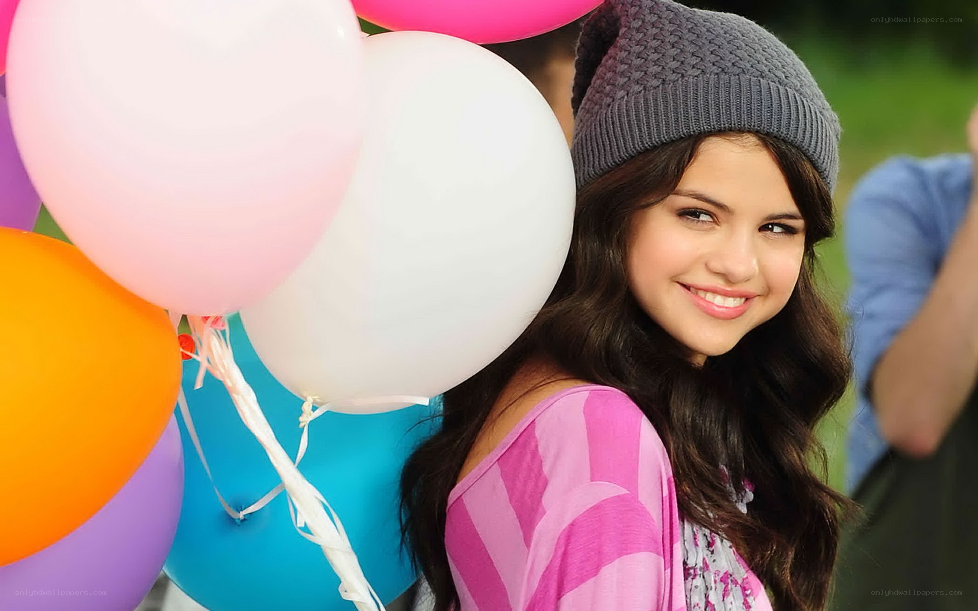 woman with balloons smiling