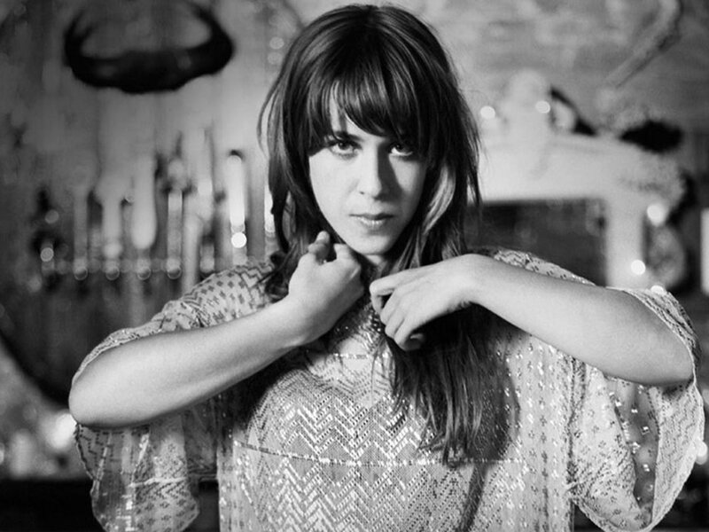 Woman with Bangs Adjusting Necklace